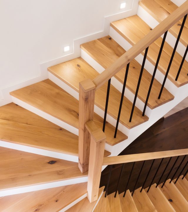 Wood staircase inside contemporary white modern house